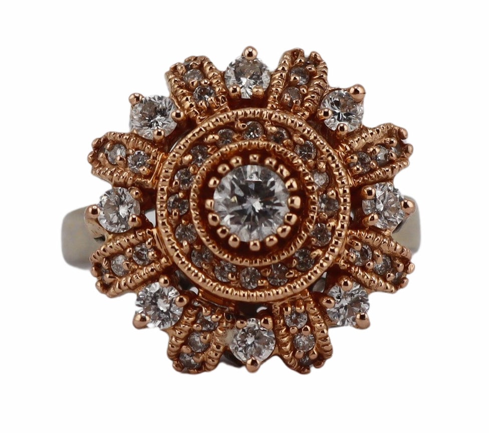 JEWELRY. 14kt Bi-Color Gold and Diamond Ring.: 14kt rose gold topped white gold circular ring displaying a central round brilliant cut diamond accented by a surround of pave diamonds and a second tier of alternating round faceted diamonds and band