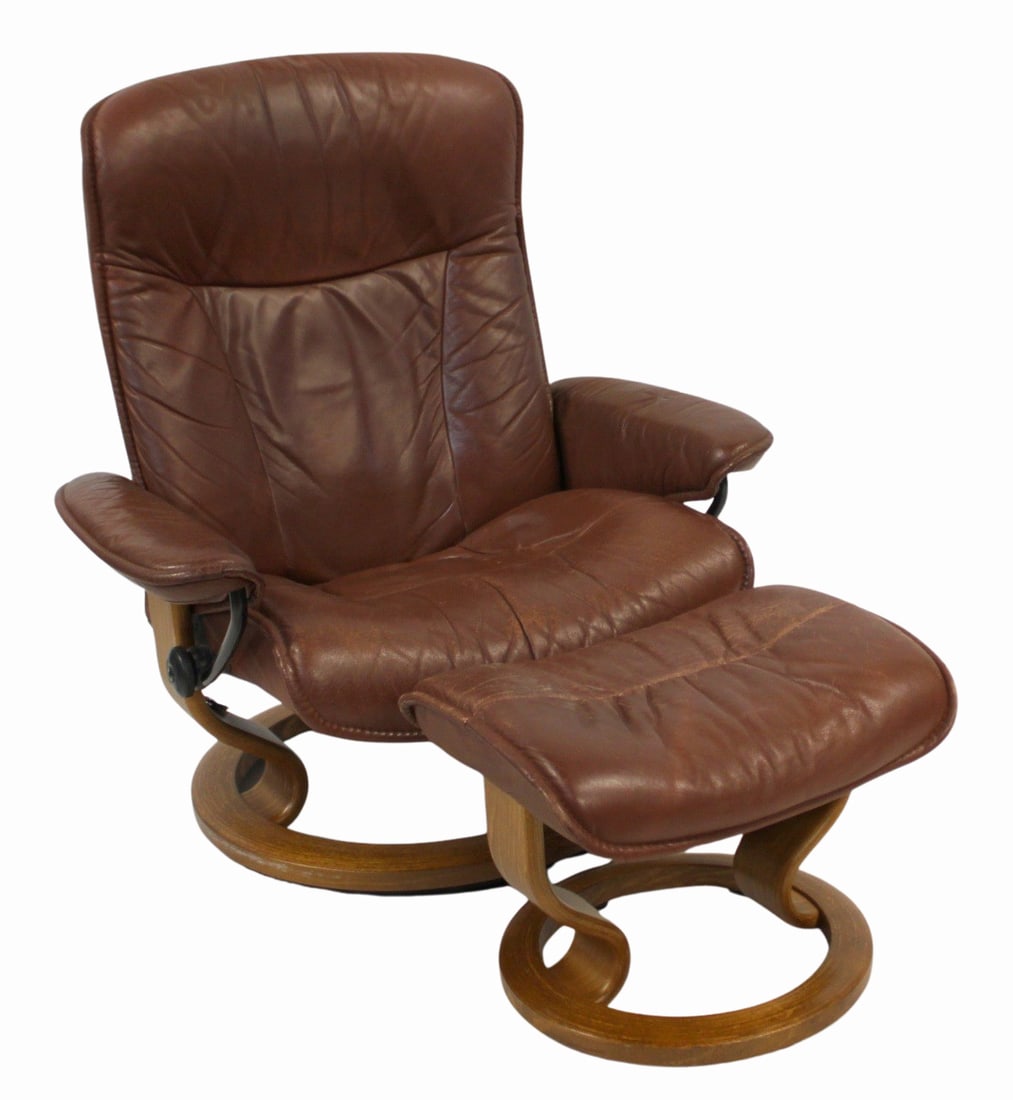 EKORNES Leather Upholstered Lounge Chair & Ottoman: From a Dobbs Ferry, NY estate. Dimensions: Chair: 40" h x 33" w x 23" d & Ottoman: 15.5" h x 21" w x 15" d