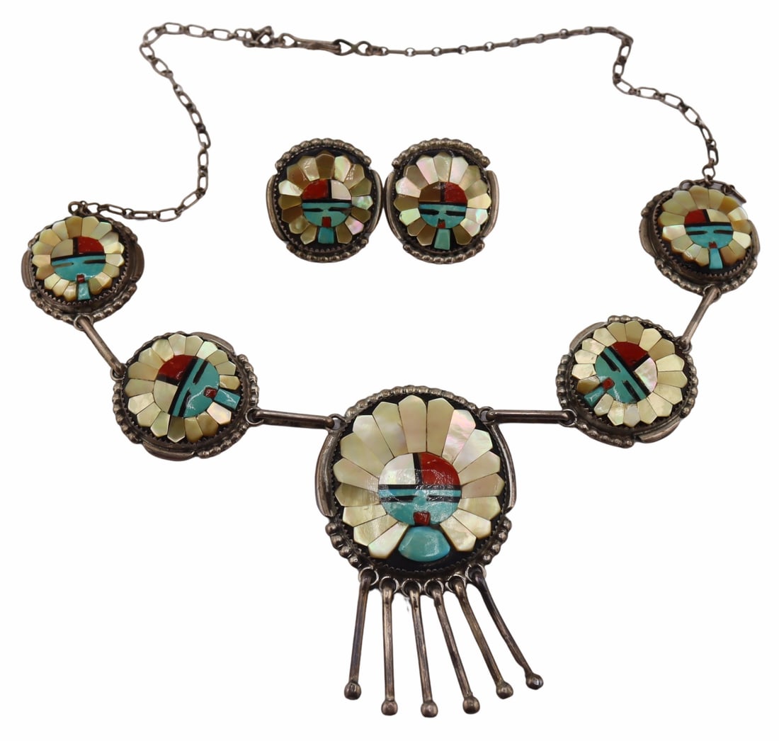 JEWELRY. Augustine and Rosalie Pinto (Zuni,: 1921-2002). Includes a signed Augustine and Rosalie Pinto Zuni 3 piece sterling and inlay sunface jewelry suite including a necklace and a pair of earrings. The largest pendant of the necklace and one