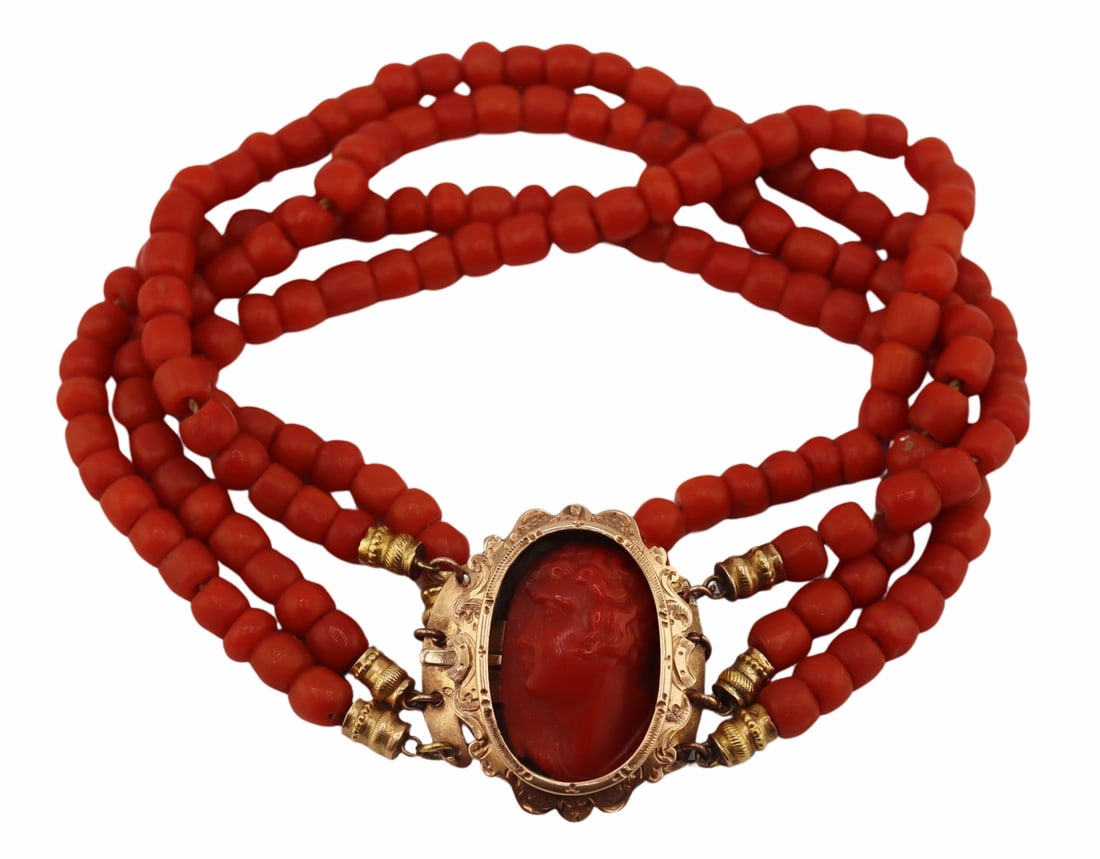 JEWELRY. Victorian Multi-Strand Coral Beaded: Bracelet. Victorian multi-strand coral beaded bracelet displaying a Dutch 14kt yellow gold clasp with central carved coral cameo accented by an etched scalloped edge surround, and further displaying g