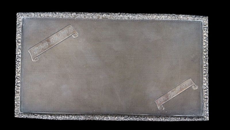 SILVER. Well Executed English Silver Hinged Box.: An engraved well executed English silver cigarette box with a Clous de Paris texture and a frieze floral border With a city mark of London, maker's mark of Goldsmiths & Silversmiths Co. Ltd., and