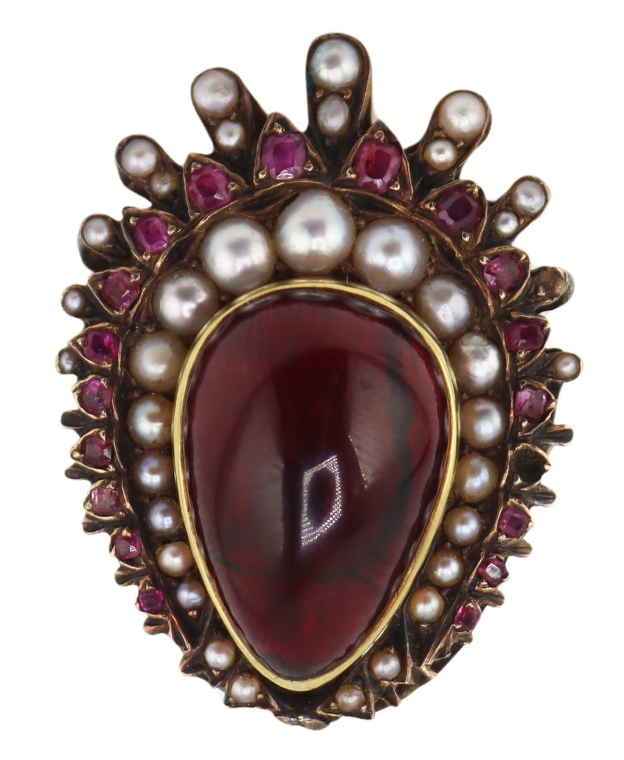JEWELRY. Antique Garnet Ruby and Seed Pearl: Cocktail Ring. Antique 12.5kt yellow gold cocktail ring displaying a large bezel set pear form garnet cabochon with tapered crown of seed pearls, round faceted rubies, and graduated seed pearl "s