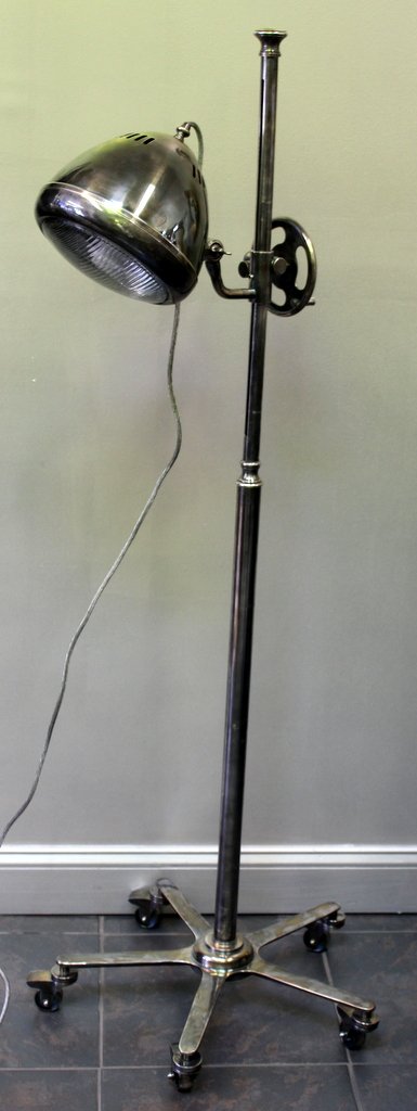 Industrial Adjustable Floor Lamp with Rolling Base: From a Flushing, NY location. Dimensions: 24" diameter x 63" high.
