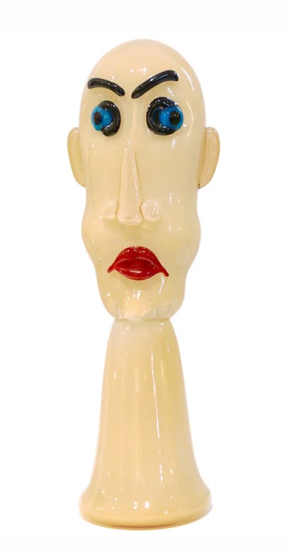 Formia 1980s Modern Italian Comic Ivory Glass Head: Sculpture. 1980s modernist dynamic, comic face sculpture in mouth-blown Murano glass. The glass paste has a tint of ivory milk white to resemble the skin complexion with blue eyes and red lips. A