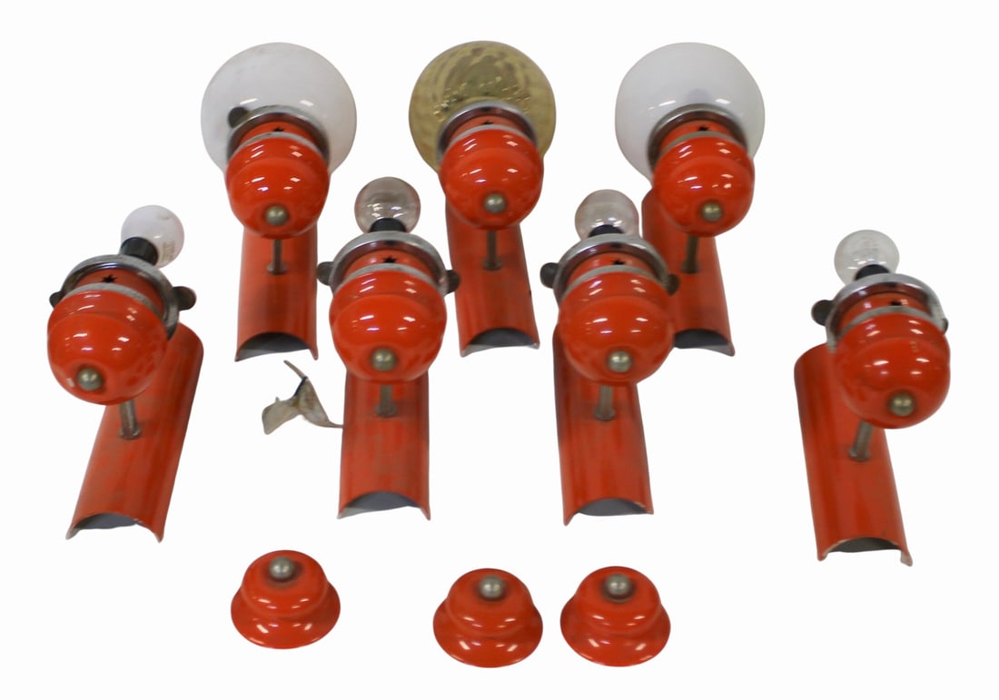 (7) Midcentury Orange Enameled Sconces.: Displaying pierced "cut out" star design. Several with globe form shades. From the curated 40+ year collection of Cosulich Interiors and Antiques. Dimensions: 8.5" x 7".