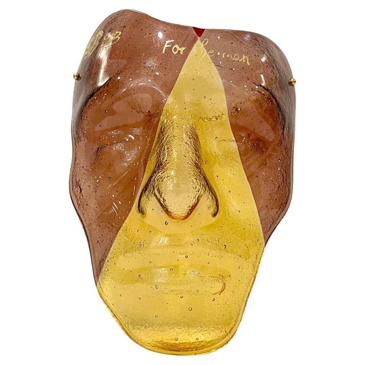Venetian Murano Glass 3D Modern Mask: "For the man" Venetian Murano Glass 3D Modern Mask, in golden amber glass with 2 opposite sides in amethyst color intersecting at the top to highlight a small red accent on the forehead. Blo