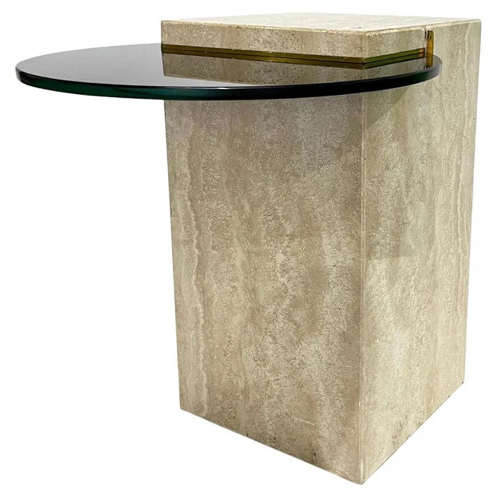 Italian Modern Travertine Black Glass Side Table: Elegant postmodern side table featuring a solid ivory cream travertine marble rectangular base paired with a striking round smoked beveled glass top. The 1/2 inch tempered glass is outlined by brass d