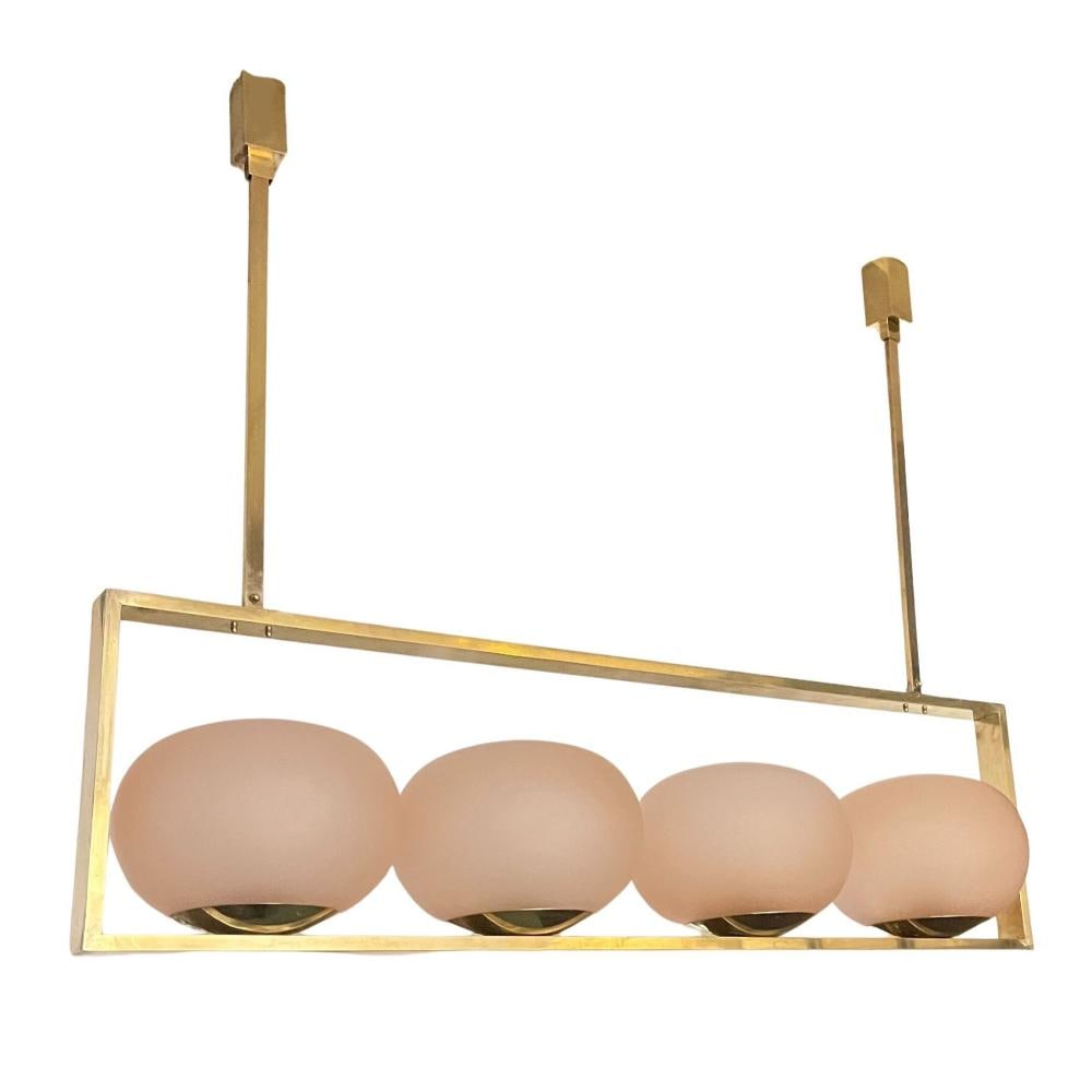 Contemporary Pink Globe and Gilt Metal Hanging: Light Fixture. Displaying four pink globe form shades. From the curated 40+ year collection of Cosulich Interiors and Antiques.