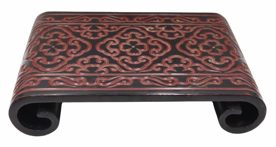 Chinese Red and Black Guri Lacquered Stand.: With 4-character Xuande mark of the Ming Dynasty. From a White Plains, NY estate. Dimensions: stand measures approx. 15" w x 10.25" d x 3.125" h.