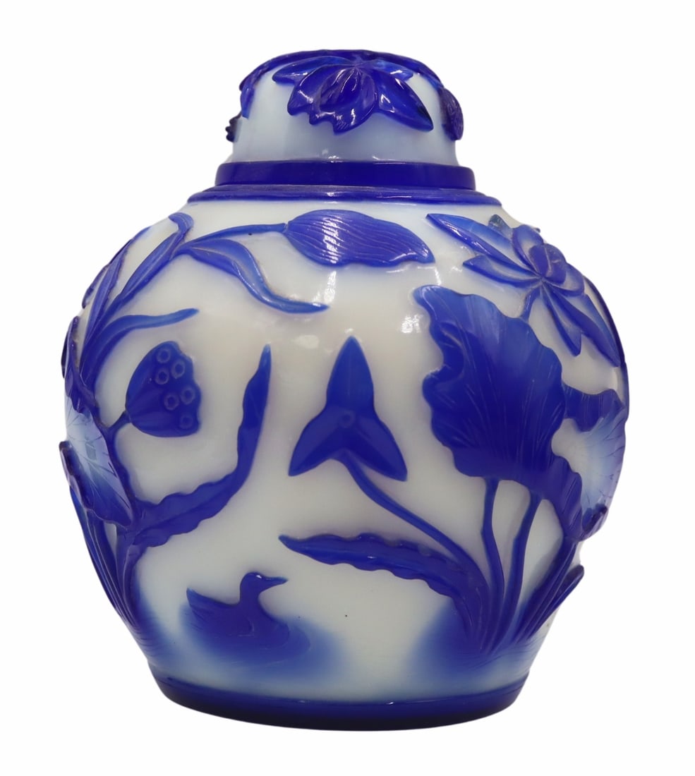 Chinese Blue and White Peking Glass Lidded Urn.: Decorated with flora and ducks. From a White Plains, NY estate. Dimensions: lidded jar measures approx. 6.5" high.