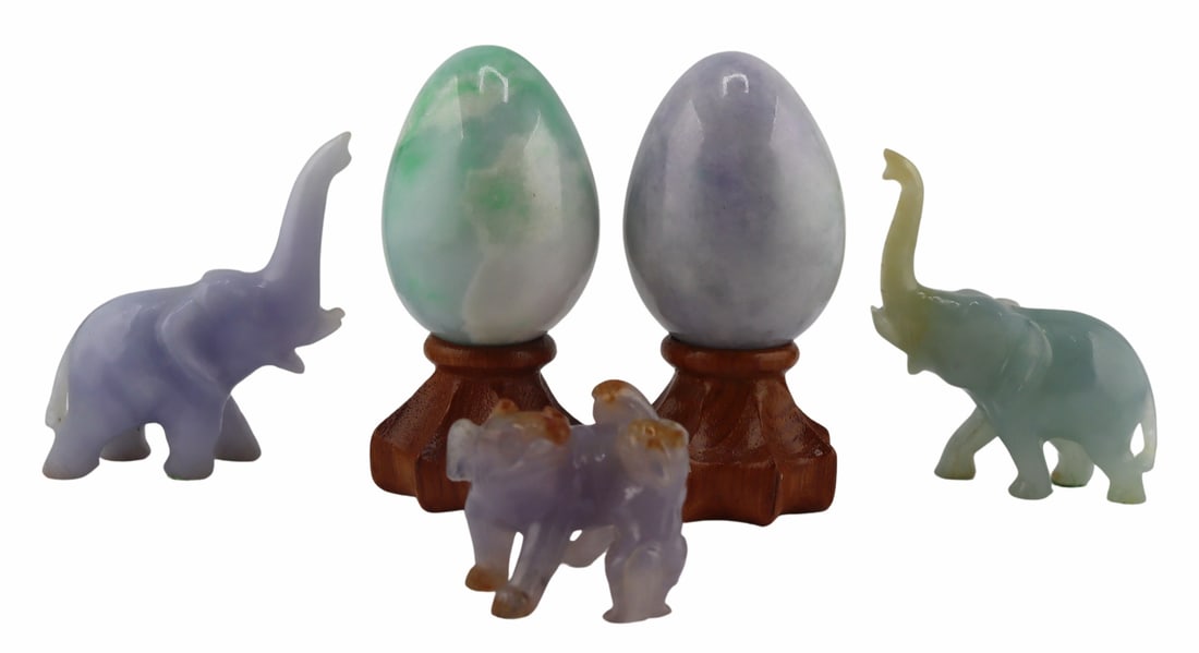 Collection of Green and Lavender Jade Objects.: Includes a Chinese carved lavender jade figural grouping of a Pekingese dog and pup - displaying russet skin; a Chinese carved green jade elephant with raised trunk; a Chinese carved lavender jade