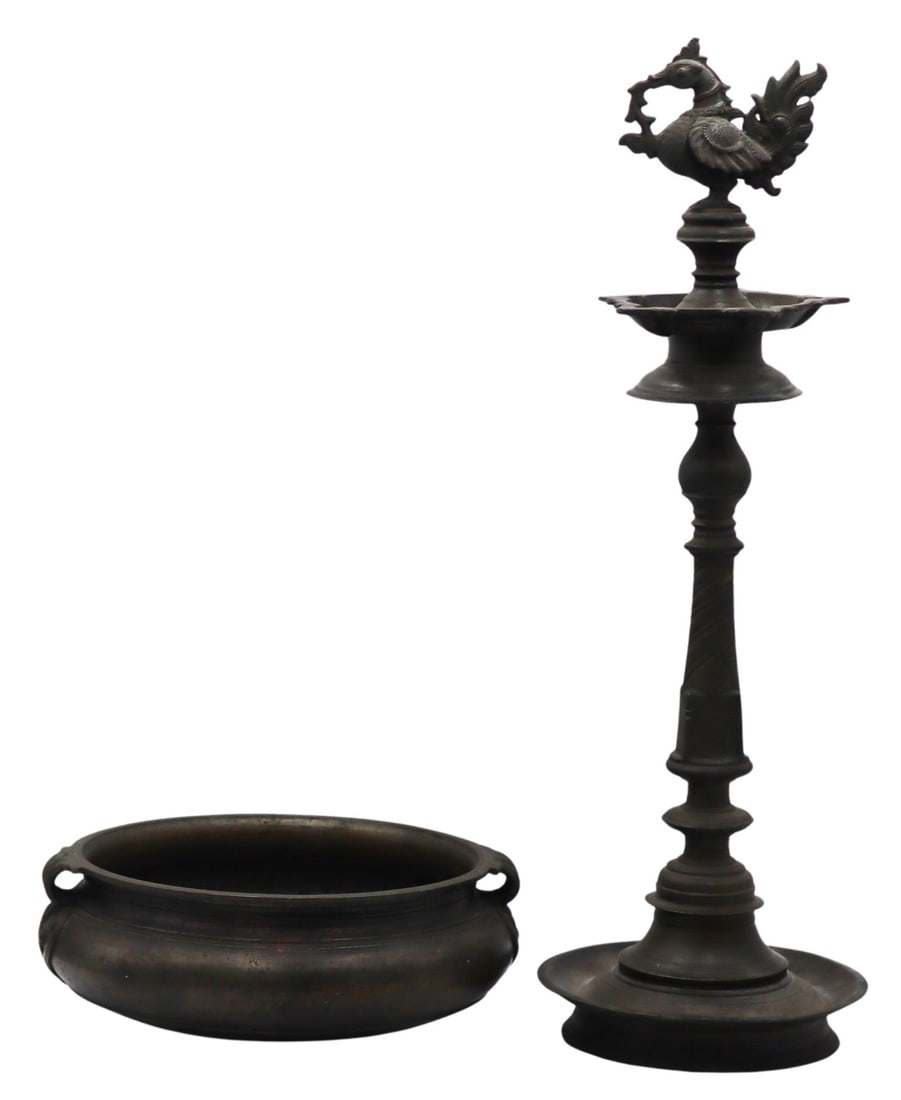Deccani Style Bronze Oil Lamp with Hamsa Finial.: Accompanied by a Chinese? archaic style bronze urn with ruyi pendant form handles. From a Manhattan, NY estate. Dimensions: oil lamp measures approx. 24.5" h; urn measures approx. 11.75" in