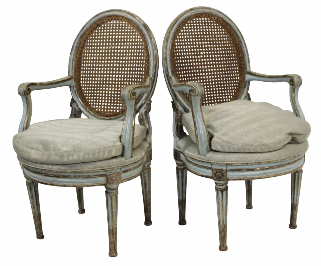 A Fine Pr Of Louis XV1 Cane Back Arm Chairs: Nice quality, paint decorated, caned backs and down filled cushions. From a 740 Park Ave, NYC estate. - Dimensions: 36.75" x 21" x 19"