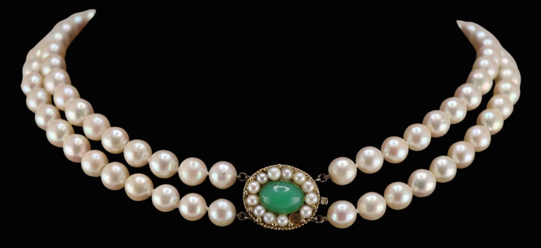 JEWELRY. 14kt Gold Pearl and Jade Double Strand: Necklace. Individually knotted double strand pearl necklace with an oval 14kt yellow gold clasp accented by a central oval jade cabochon and pearl surround. Stamped, "14K" verso. Total appro