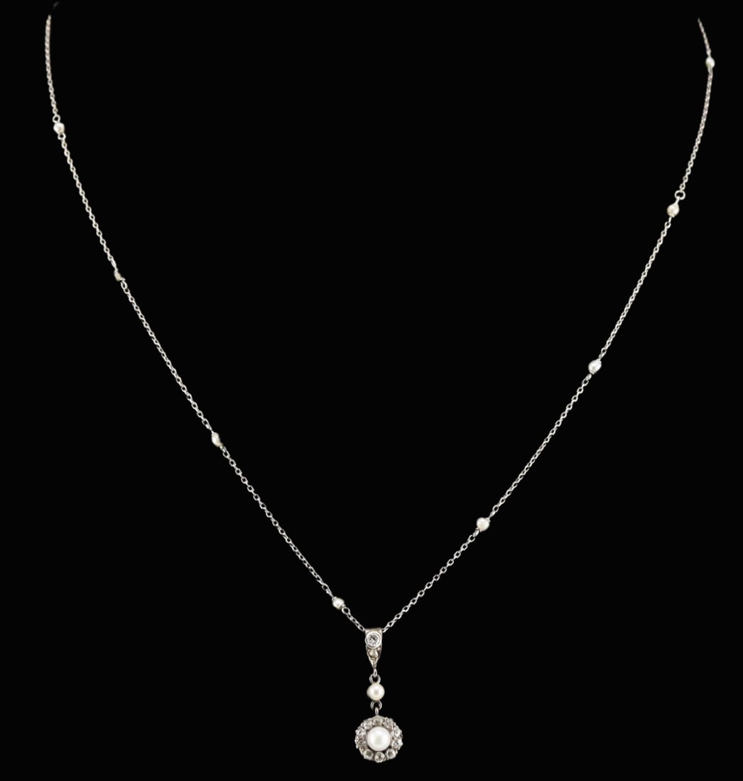JEWELRY. Platinum, 13kt Gold, Diamond and Pearl: Necklace. 13kt white gold pendant displaying a central pearl measuring approx. 4.0mm with a surround of Old European cut diamonds suspended from a single seed pearl and a tapered bail with single beze