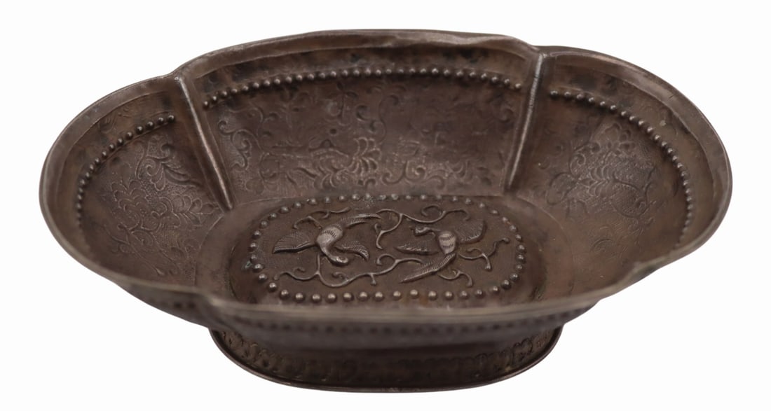 SILVER. Chinese Silver Quatrefoil Form Bowl with: Birds. Antique, Ming Dynasty, Chinese silver repousse quatrefoil form bowl with central depiction of a pair of mythical birds flying amongst scrolling vines. The exterior of the bowl displays birds