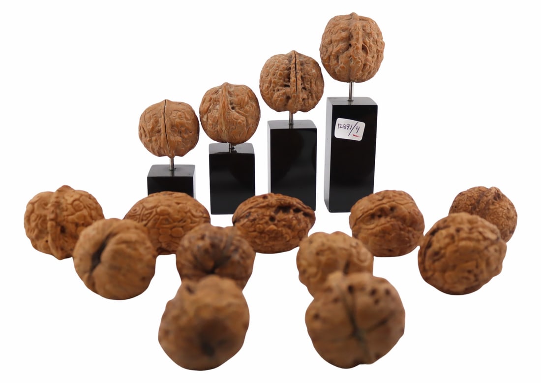 Collection of (15) Chinese Walnuts, Many Carved.: Four examples are mounted on stands. From a Cliffside Park, NJ estate. Dimensions: walnuts measure on average approx. 1.60" w x 1.50" d x 1.55" h.