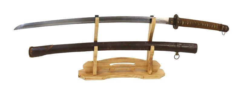 MILITARIA. Imperial Japanese Type 98 Shin Gunto: Sword. This katana features a well executed blade, a leather wrapped wood saya with one hanger, a tsuba, wrapped tsuka, chrysanthemum manuki, and (4) seppa. From a Westchester, NY estate.