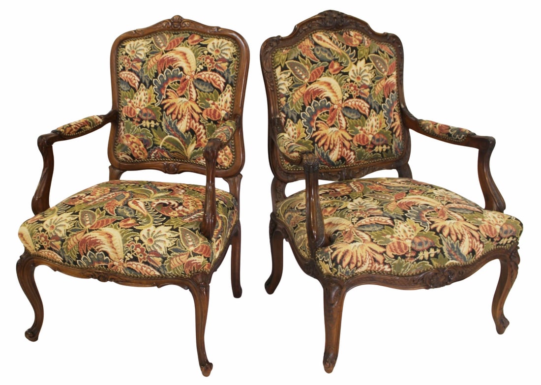 Matched Pair of Louis XV Style Armchairs.: Both finely carved and very similar with needlepoint style upholstery. From a Bronxville, NY estate. Dimensions: 41.5" x 23.5" w x 20" d and 42" h x 26.5" w x 23.5" d.