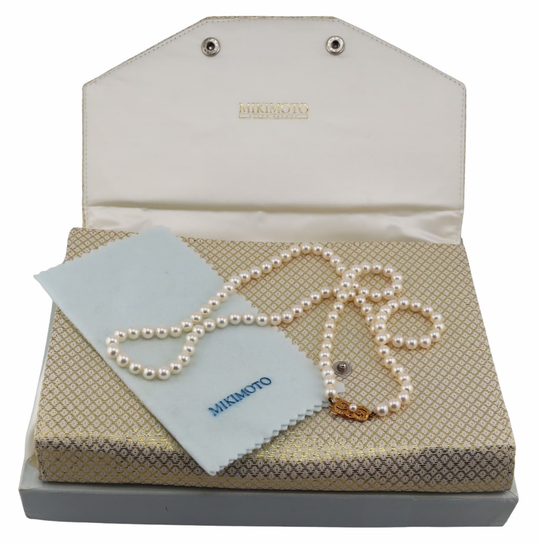 JEWELRY. Mikimoto 18kt Gold and Pearl Necklace.: Mikimoto individually knotted graduated pearl necklace with 18kt yellow gold clasp accented by a single pearl. Pearls vary in size approx. 6.0mm - 6.5mm. Clasp is stamped, "750" with a Mikim