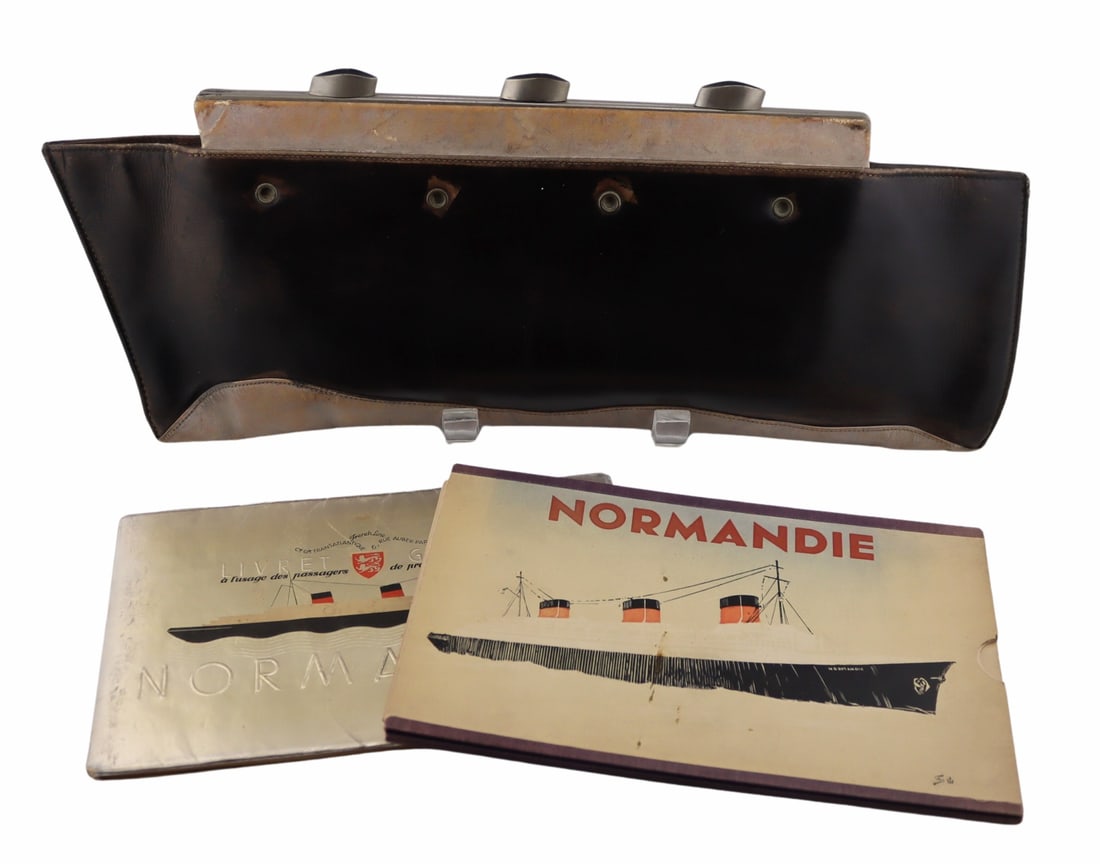 Normandie Leather Ship Form Purse and Ephemera.: Clutch bag in the shape of The S.S 'Normandie' ocean liner, about 1935, British Made. Black and silver leather with chromed metal clasp and silk interior. Accompanied by a Normandie First Class
