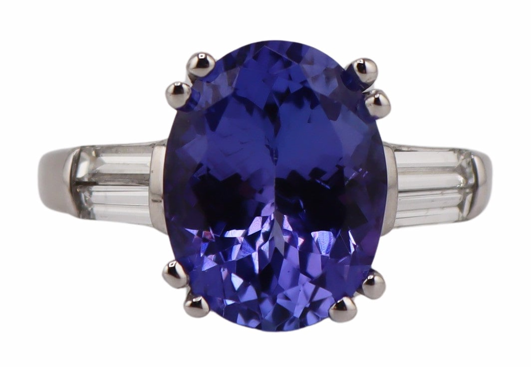 JEWELRY. M&S 14kt Gold Tanzanite and Diamond Ring.: Signed M&S 14kt white gold, oval faceted Tanzanite and (4) tapered diamond baguettes ring. Stamped, "M&S 14K" to the interior of the band. Total approx. weight of the ring is 4.3 dwt