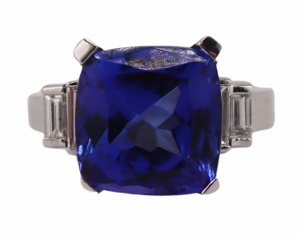 JEWELRY. 14kt Gold Tanzanite and Diamond Ring.: Signed 14kt white gold cocktail ring displaying a central prong-set faceted Tourmaline flanked by (4) tiered straight diamond baguettes. Interior of the band is stamped, "M&S 14K SAR'S".