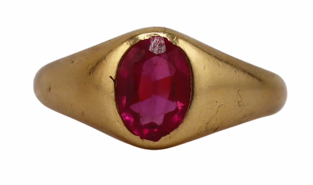 JEWELRY. French 18kt Gold and Diamond Ring.: French 18kt yellow gold tapered band ring displaying a central flush set oval faceted ruby. Ruby measures approx. 7.5mm x 5.5mm. With a French gold hallmark of an owl set within an oval frame signifyi