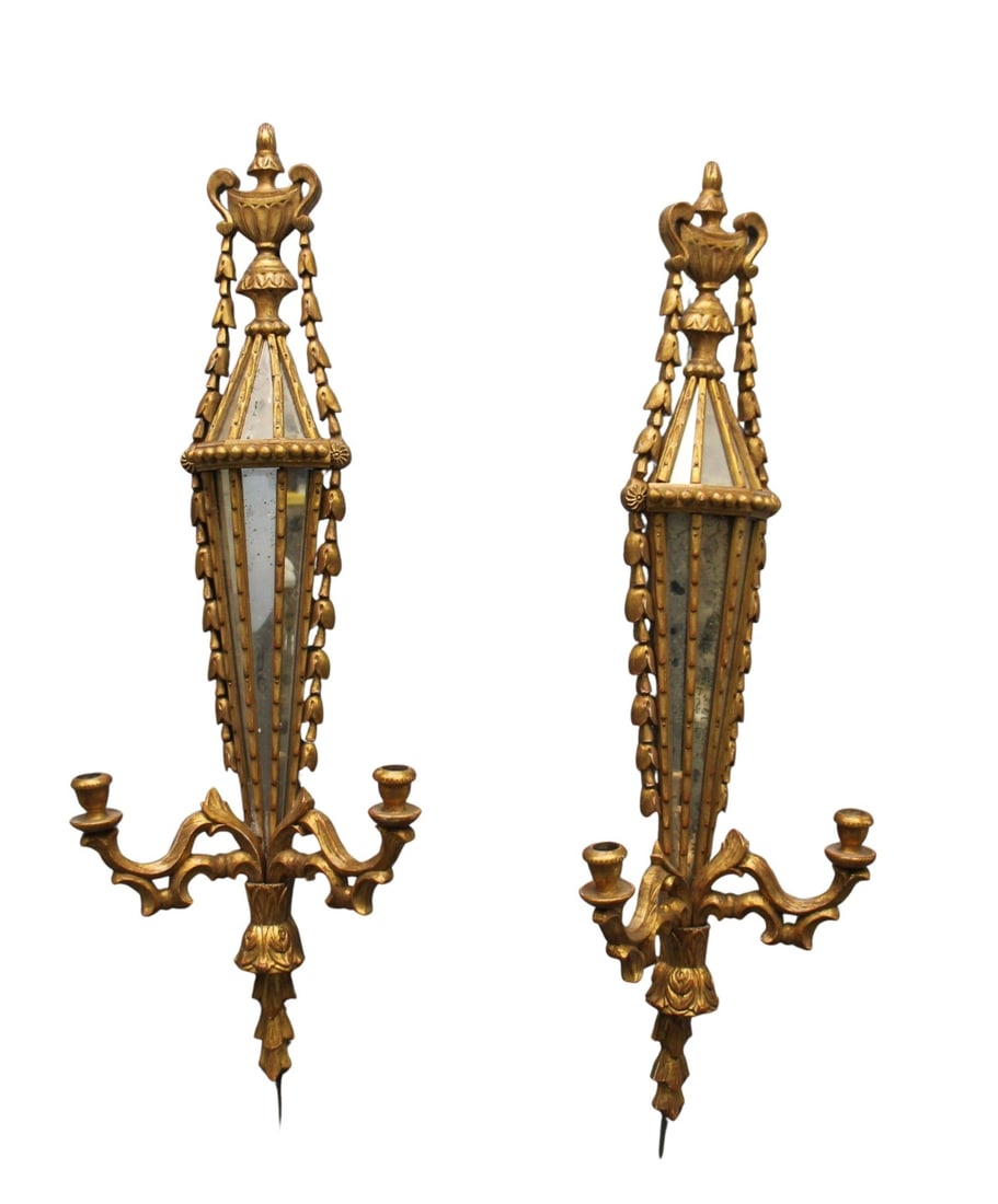 A Pair of Antique Gilt Wood & Mirrored Sconces: A pair of antique gilded wood and mirrored candle sconces. From a Bronx, NY collection. - Dimensions: 37" h x 12" w x 5" d.