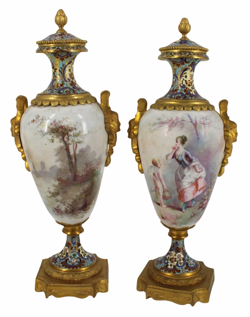 Pair of Bronze Mounted & Enameled Sevres Style: Porcelain Urns. The best of quality with hand painted scenes, one signed Daly, and fine enameling and bronzes. From a Jamesville, NY estate. - Dimensions: 13.75" h.