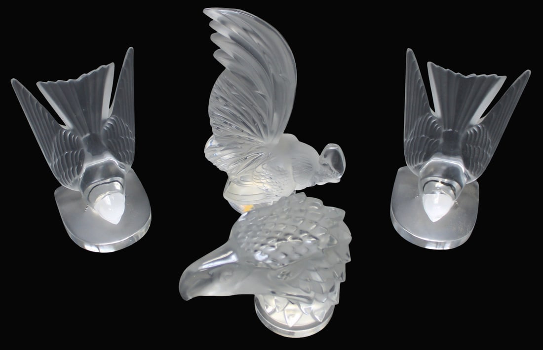 Lalique France Grouping of 4 Pieces of Glass.: To include an Eagle mascot (4.25" h x 5.25" w), a pair of Swallow form bookends (6.5" h), and a Rooster (8.5" h). From a New Rochelle, NY estate.