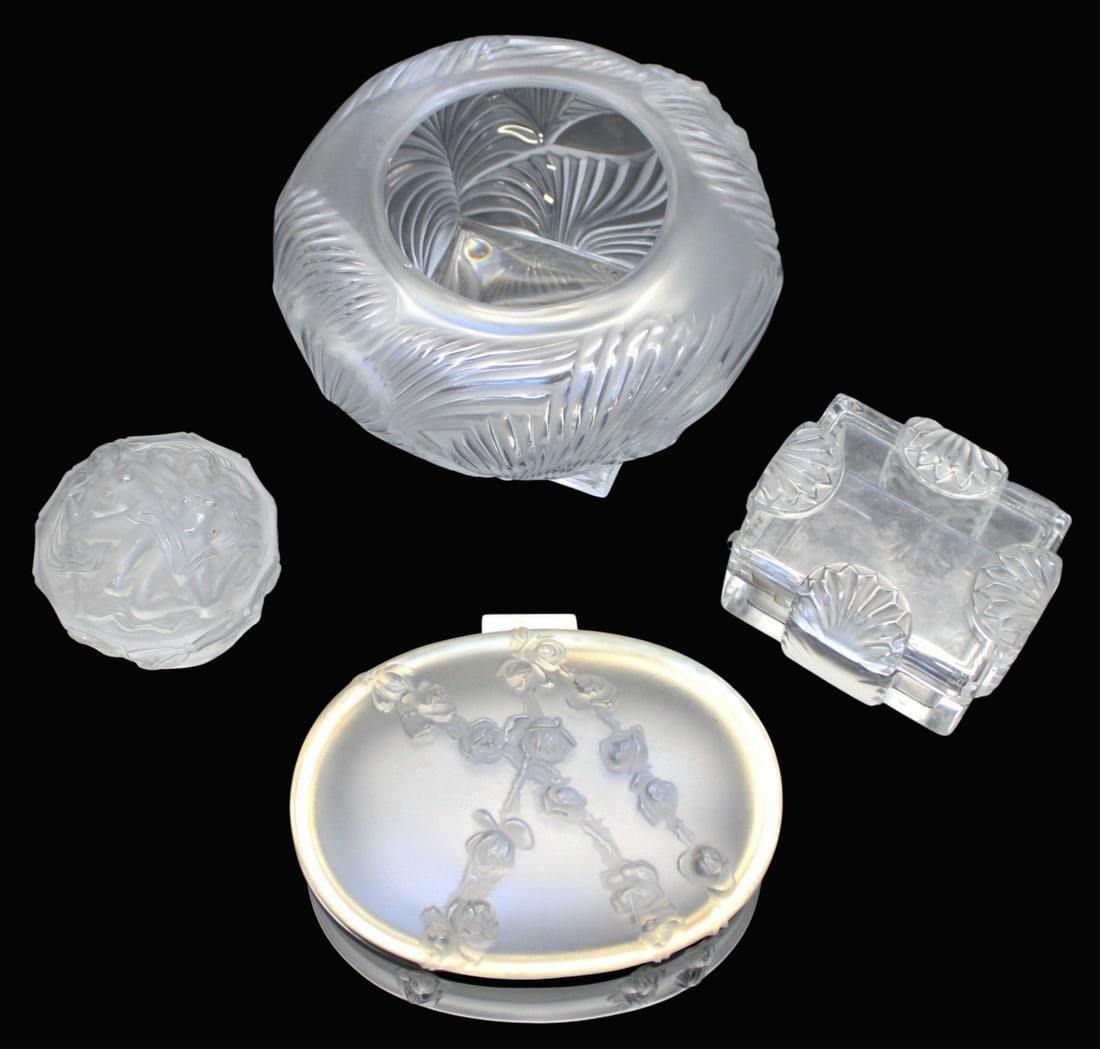 Lalique Crystal 4 Piece Grouping: To include: 1) Lalique "Hutan" bowl (small flea bite top edge), 2) Covered box, (4 7/8" x 4.25"), 3) Covered box with entwined nudes, 4", Large oval box with hinged cover,