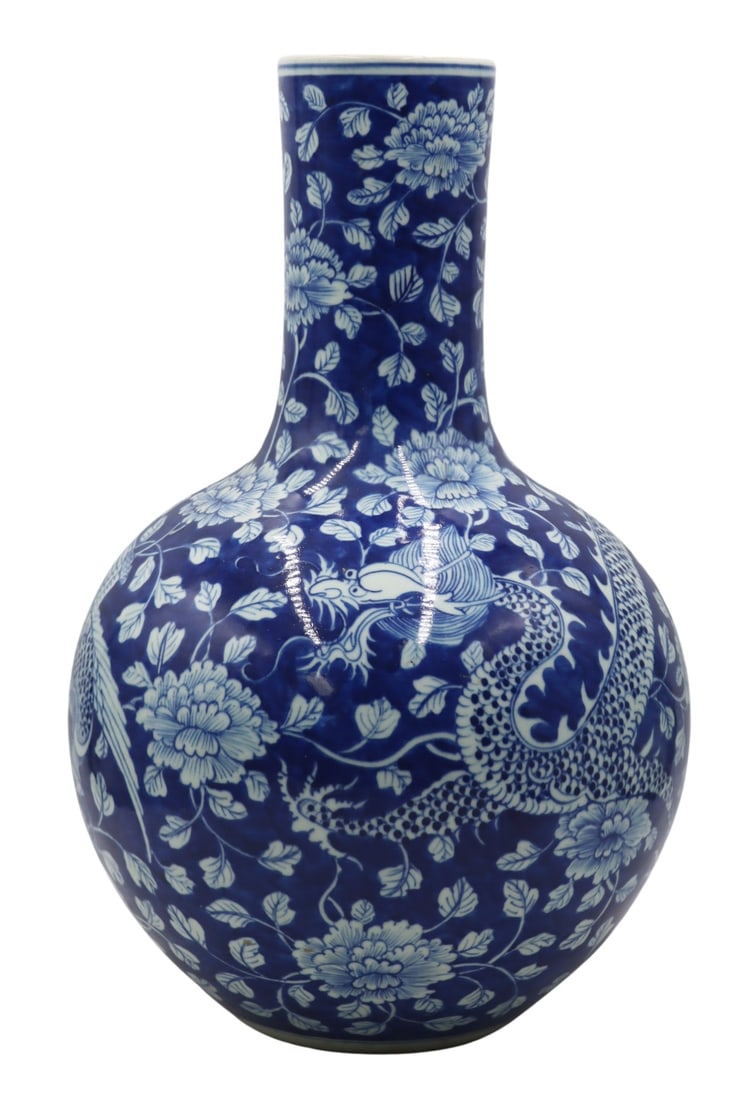 Large Chinese Blue and White Dragon and Phoenix: Vase. Large Chinese blue and white vase displaying a dragon and phoenix set amongst chrysanthemums and flora. From a Great Neck, NY estate. Dimensions: vase measures approx. 19" h.