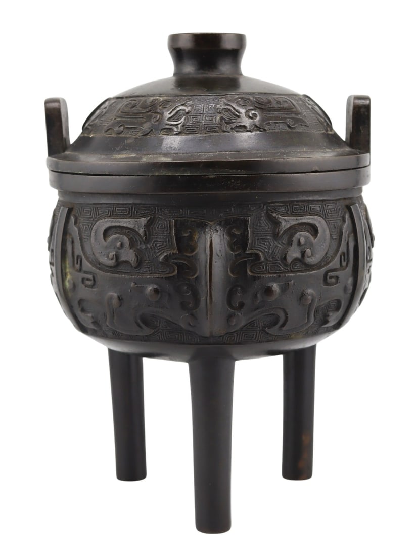 Chinese Archaic Bronze Lidded Tripod Censer.: Chinese Archaic style bronze lidded tripod censer. Total approx. weight of the lidded censer is 1059.7 grams (gross). From a Great Neck, NY estate. Dimensions: 4.375" w x 4.5" d x