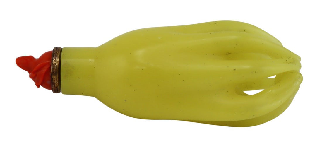 Ex-Bonham's Yellow Glass Buddha's Hand Snuff: Bottle. Ex-Bonham's opaque yellow glass Buddha's hand or finger citrus snuff bottle. With carved salmon coral stopper of foliate motif. From the Robert and Florette Weiss Collection of Chinese Snuff B