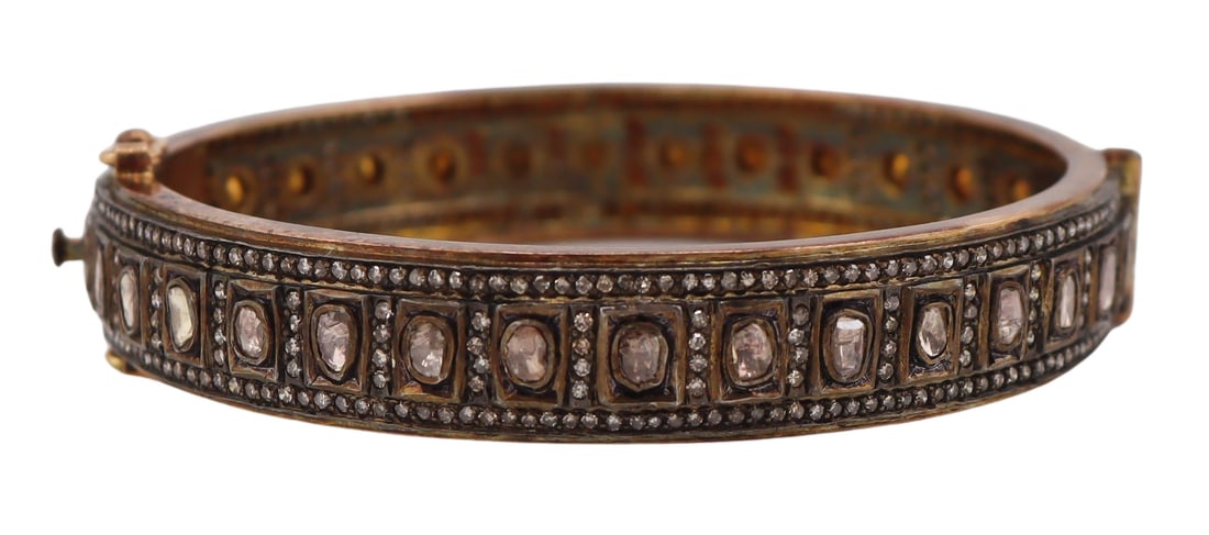 JEWELRY. Indian 14kt Gold Silver and Polki Diamond: Bracelet. Indian 14kt yellow gold and silver hinged bracelet displaying a central band of polki diamonds accented by pave diamonds. Apparently unmarked. Total approx. weight of the bracelet is 33.5 gr