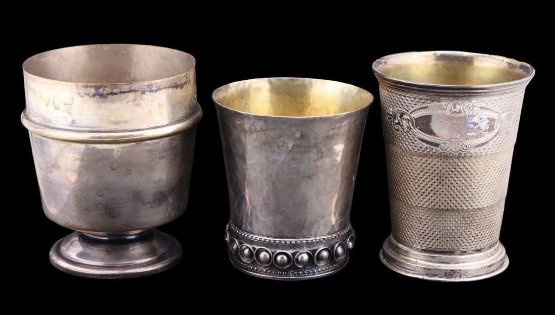 SILVER. (3) Continental Silver Beakers.: Including an .800 silver cup - stamped "800" alongside a pictorial maker's mark; a Loth .812 silver travel cup - stamped, "13"; and a well executed hammered .900 silver cup with