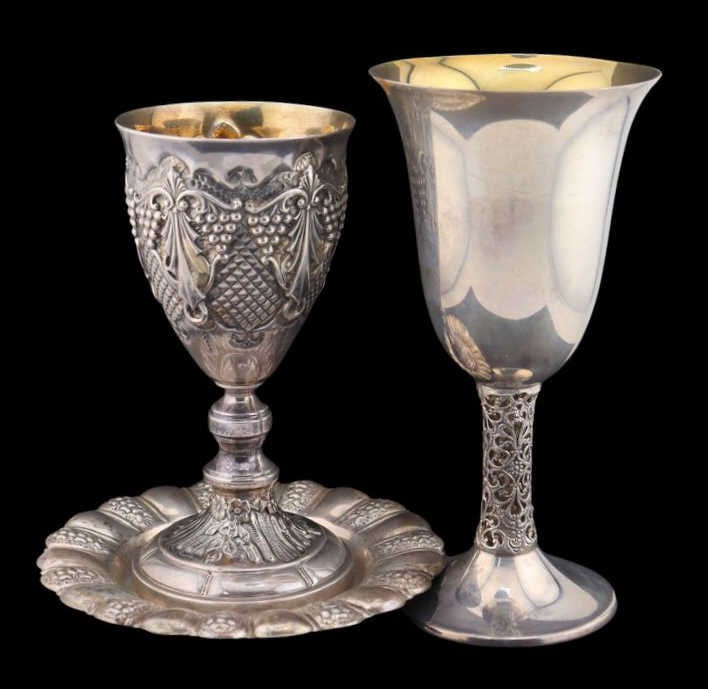 JUDAICA. (2) Assorted Sterling Kiddush Cups.: Including a sterling kiddush cup executed in repousse with an interior gold wash - stamped, "Sterling"; a sterling kiddush cup with an interior gold wash and an open work stem - stamped,