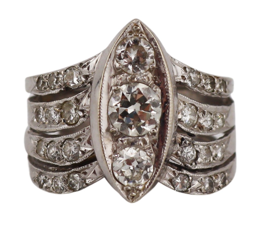 JEWELRY. 13kt Gold and Diamond Multi-Band Ring.: 13kt white gold multi-band ring displaying a central navette form pendant accented by (3) Old European cut diamonds set within (4) tapered bands accented by round faceted pave diamonds. Largest