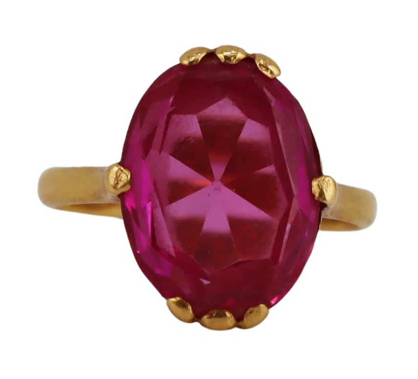 JEWELRY. Chinese 21kt Gold and Faceted Gem Ring.: Chinese 21kt yellow gold ring displaying a central oval faceted pink gem. Gem measures approx. 10.0mm x 13.5mm. Stamped to the interior of the band, "4" with a Chinese gold hallmark