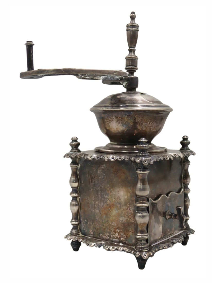 SILVERPLATE. French Silverplate Coffee Grinder.: With pierced cherub decoration to the handle. From a Ryebrook, NY estate. Dimensions: coffee grinder measures approx. 4.25" w x 4.25" d x 10.25" h excluding the handle; handle measures