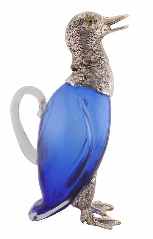 SILVERPLATE. Novelty Duck Form Claret Jug.: A whimsical silverplated mounted glass novelty duck form claret jug, modeled as a standing duck with finely detailed plumage throughout. From a Manhattan, NY estate. Dimensions: claret jug measures