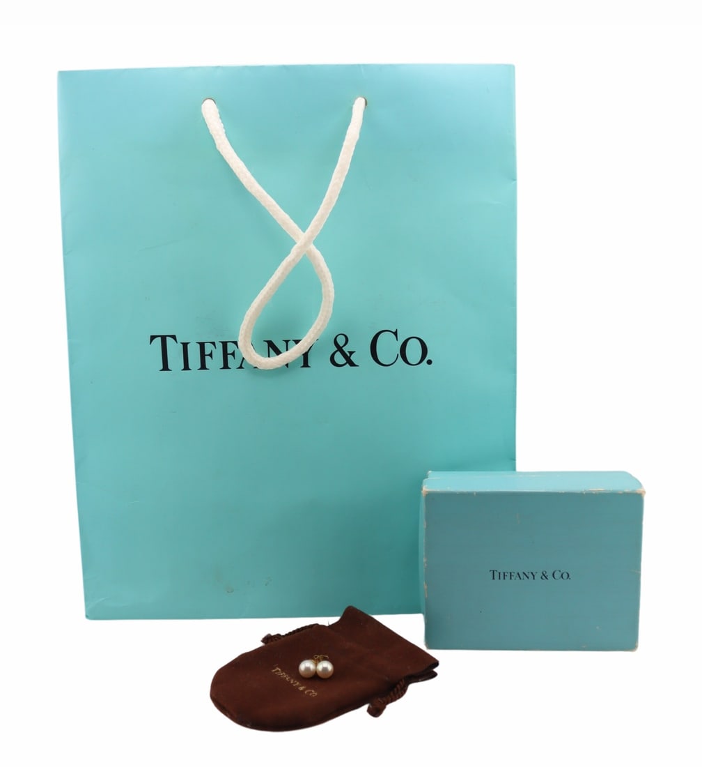 JEWELRY. Pair of Tiffany & Co. Pearl Stud Earrings: Pair of Tiffany & Co. 18kt yellow gold and pearl stud earrings. Pearls measure approx. 7.0mm. With a pair of 18kt yellow gold butterfly backings. Accompanied by a Tiffany & Co dust bag,