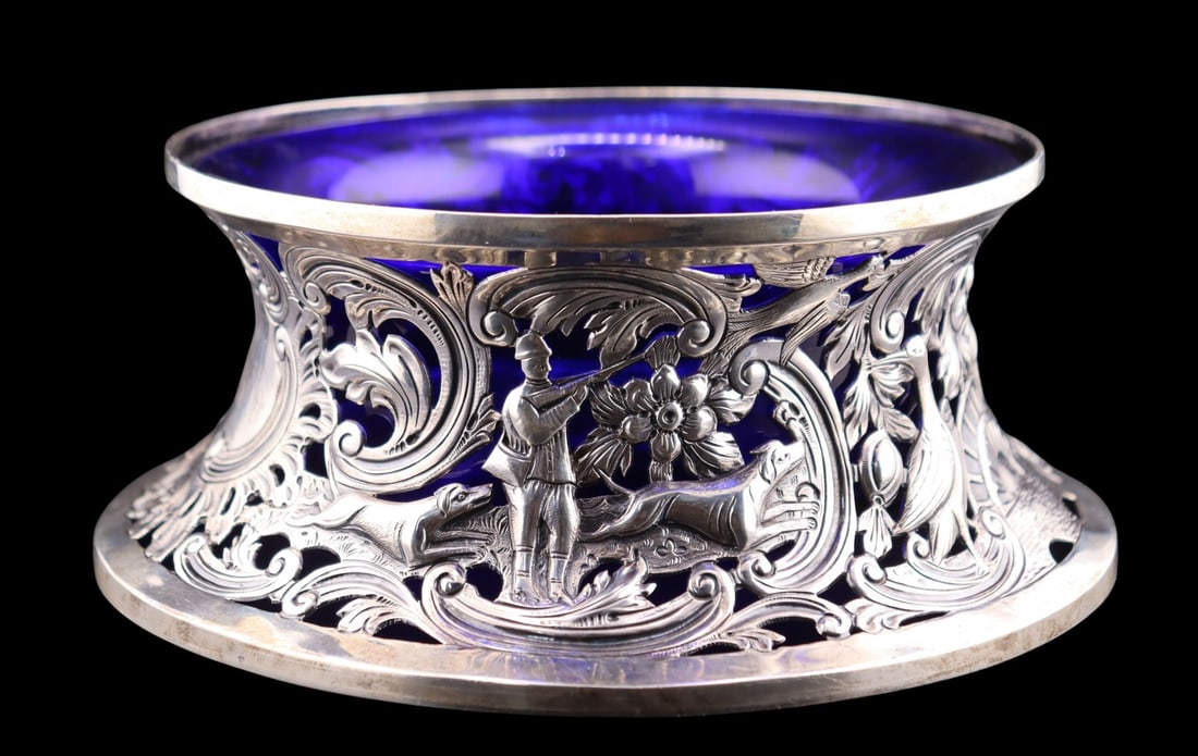 SILVER. Irish Silver Huntsman Potato Ring Bowl.: A spectacular monogrammed Irish silver potato ring featuring a cobalt blue glass liner. The openwork repousse depicts a gentleman accompanied by dogs engaged in wing shooting, most likely snipe. With