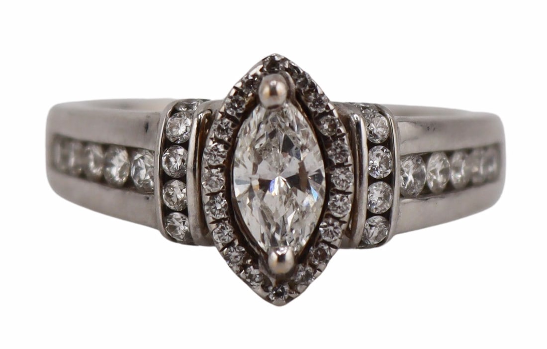 JEWELRY. 14kt Gold and 0.35ct Marquis Diamond: Engagement Ring. 14kt white gold engagement ring displaying a central 0.35ct marquis faceted diamond with pave diamond halo, a vertical pave diamond band to each shoulder, and flush set pave diamond a
