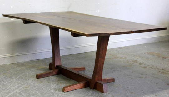 Fine and Rare George Nakashima Conoid Dining Table: A beautiful table with 3 rosewood butterfly keys on a book matched top and trestle base. With provenance documentation. From a New Canaan, CT home. Dimensions: 72" wide x 41" deep x 28.5" high. Condit