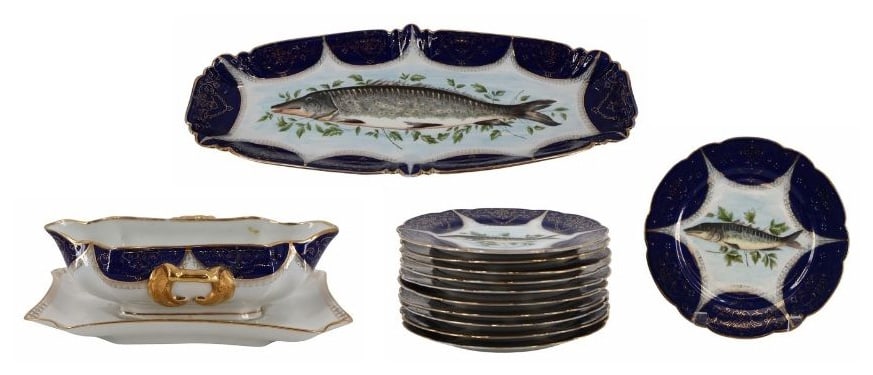 Antique Austrian Porcelain Fish Service: Consisting of 11 (8.5") plates with different fish; a gravy boat with attached underplate, and a serving platter with a large painted fish (23" x 9.75"). From a New Rochelle, NY estate.