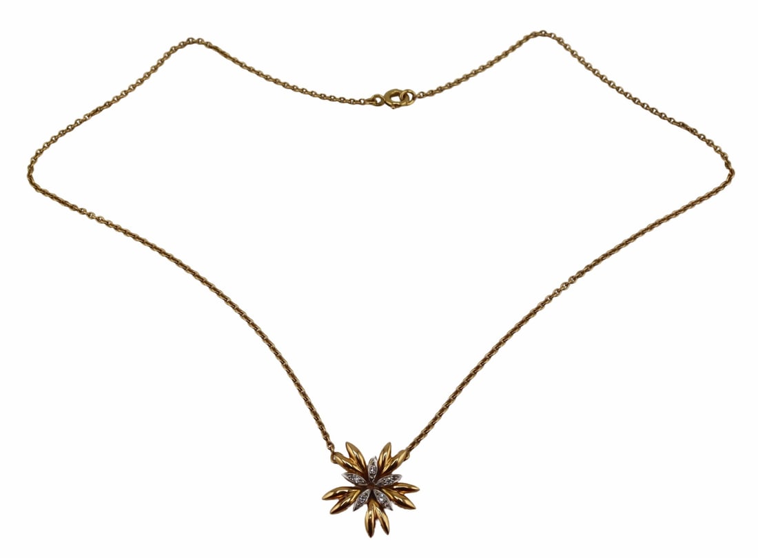 JEWELRY. French 18kt Gold, Silver and Diamond: French 18kt yellow gold and silver floral form pendant accented by (5) single cut diamonds, and suspended on an 18kt yellow gold chain. With a French eagle's head pictorial hallmark signifying a gold 