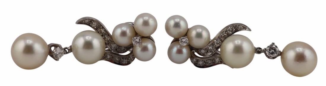 JEWELRY. 13kt Gold, Pearl and Diamond Earrings.: 13kt white gold drop earrings displaying trefoils of pearls measuring approx. 5.5mm surrounded by pave diamonds and suspending (2) pearls separated by a single prong-set round brilliant cut diamond. L