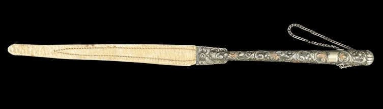 SILVER. Argentinean Gaucho Rebenque Whip.: An Argentine gaucho rebenque whip, featuring a finely worked silver handle of elongated form, decorated with scrolling foliate motifs and terminating in a looped pommel. The grip is paired with a brai